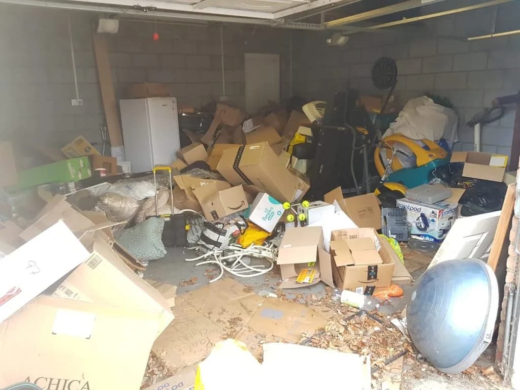 White fridge being cleared from a hoarded garage in Gravesend by Andy — fridge and appliance removal with licensed WEEE disposal