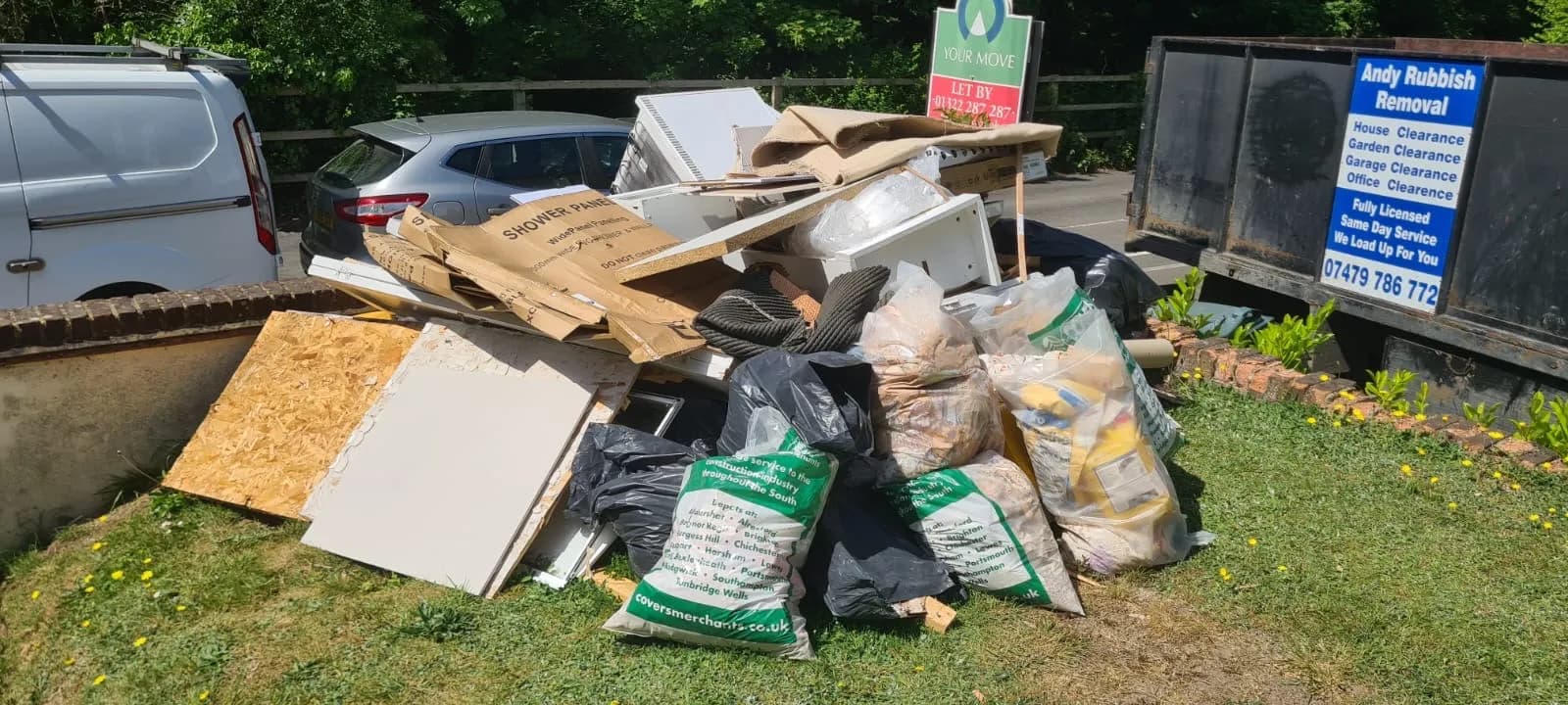 Pile of chipboard, shower panels, a rolled carpet and bagged waste on the front verge of a rental property in Gravesend, with Andy's tipper van and a YOUR MOVE Let By board behind
