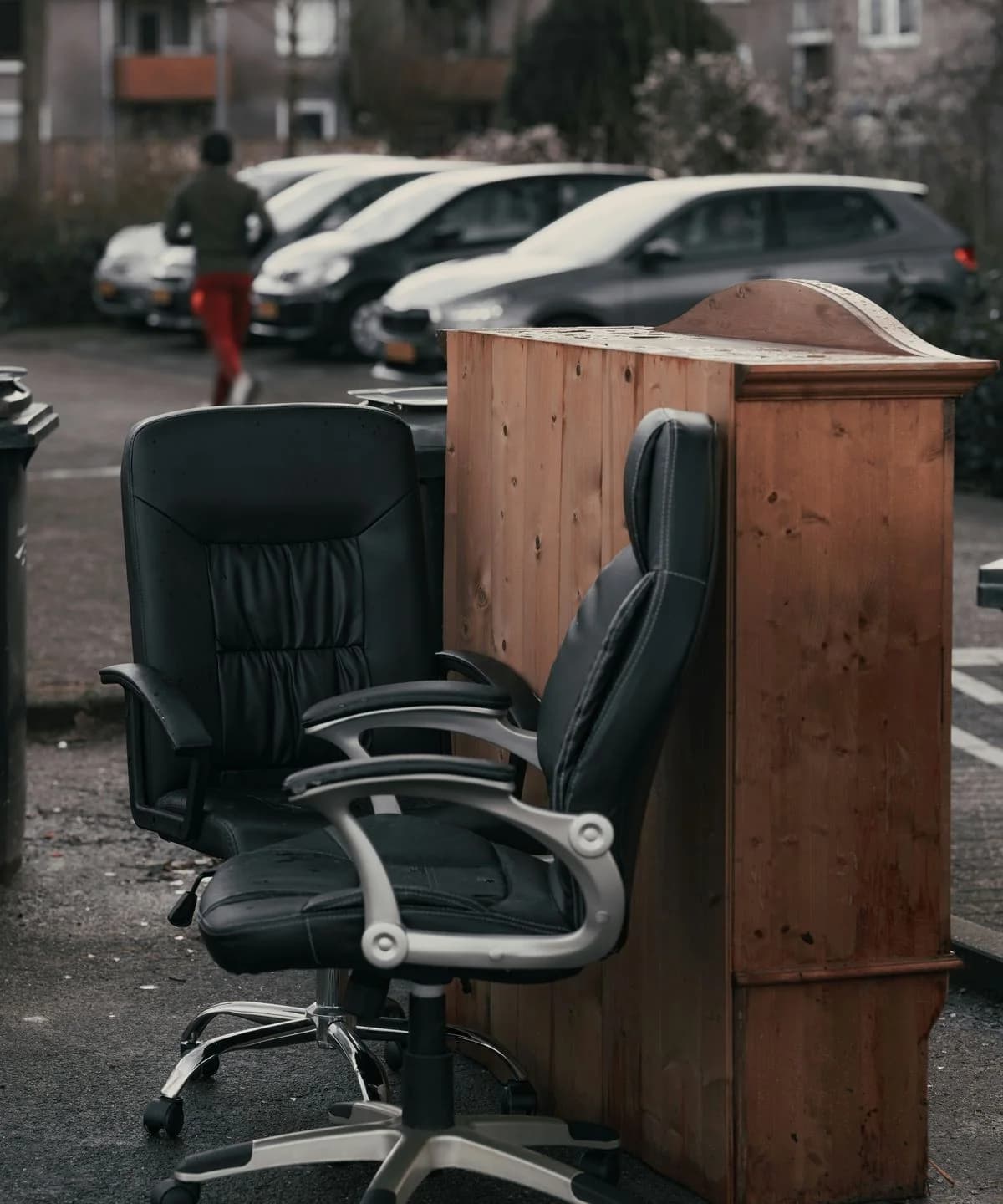Black office chairs and wooden desk left out for clearance — typical office strip-out job in Gravesend