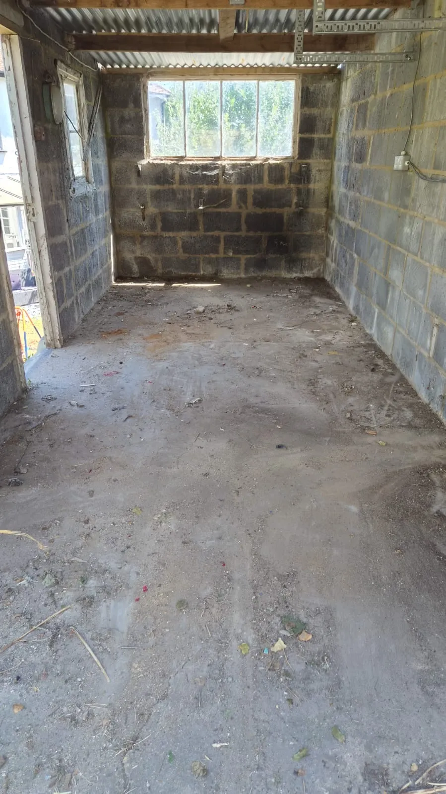 The same Northfleet garage emptied and swept out by Andy, bare floor and usable space again