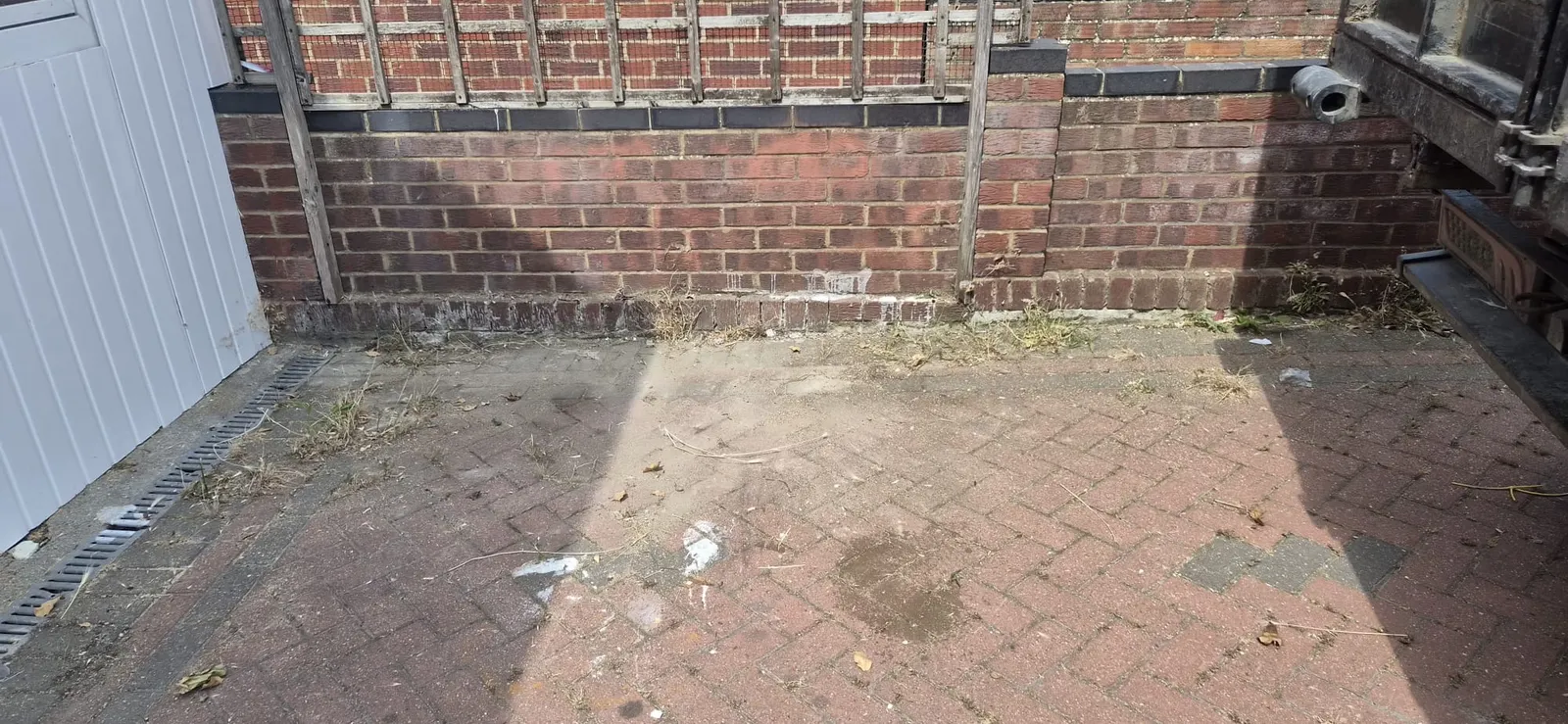 The same block paving in Gravesend swept clean after Andy cleared the renovation waste, tipper truck just in shot