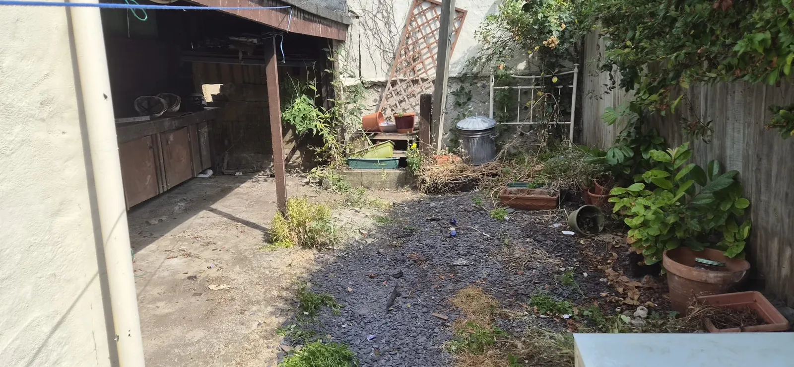 The same Gravesend back garden and lean-to cleared out, pots and planters left in place