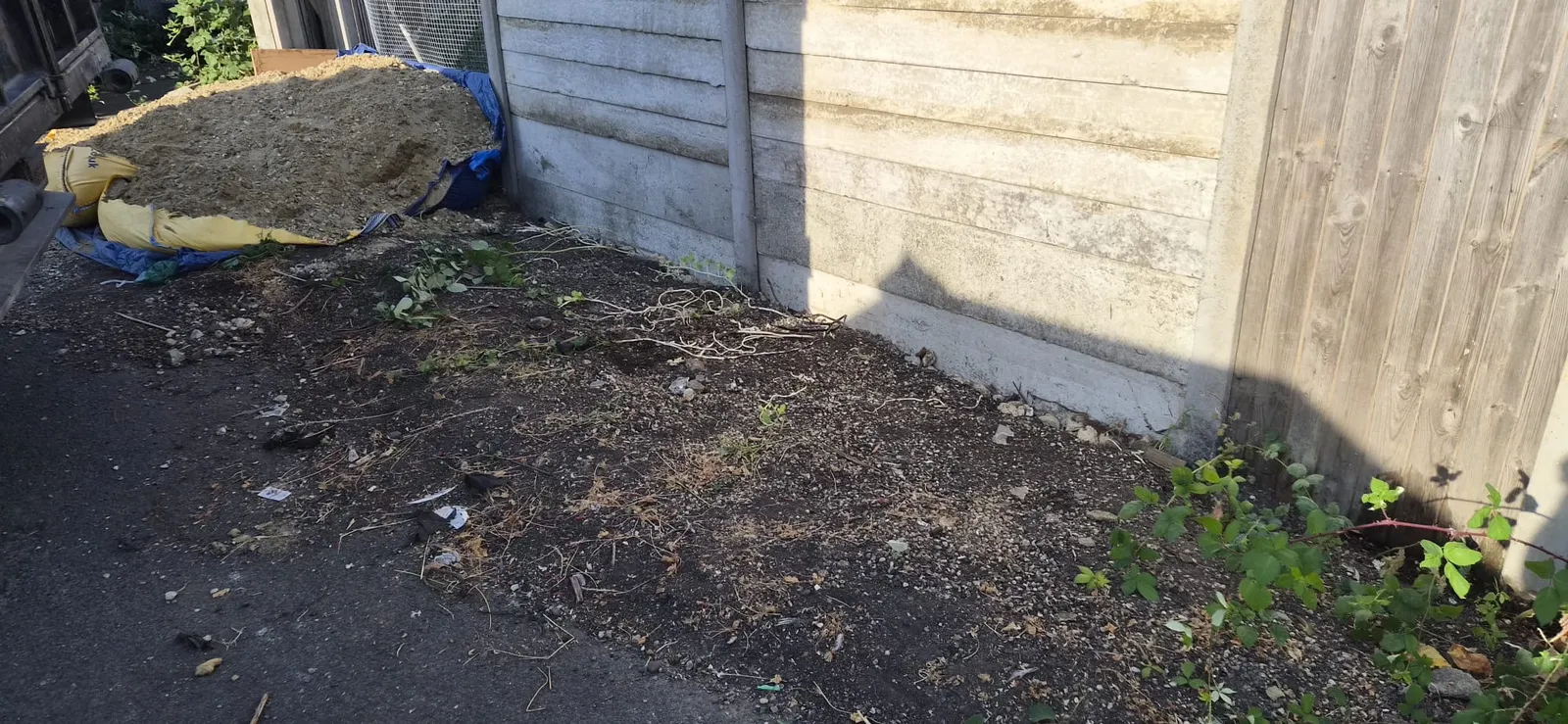 The same Northfleet fence line cleared down to bare soil after Andy removed all the bags and timber